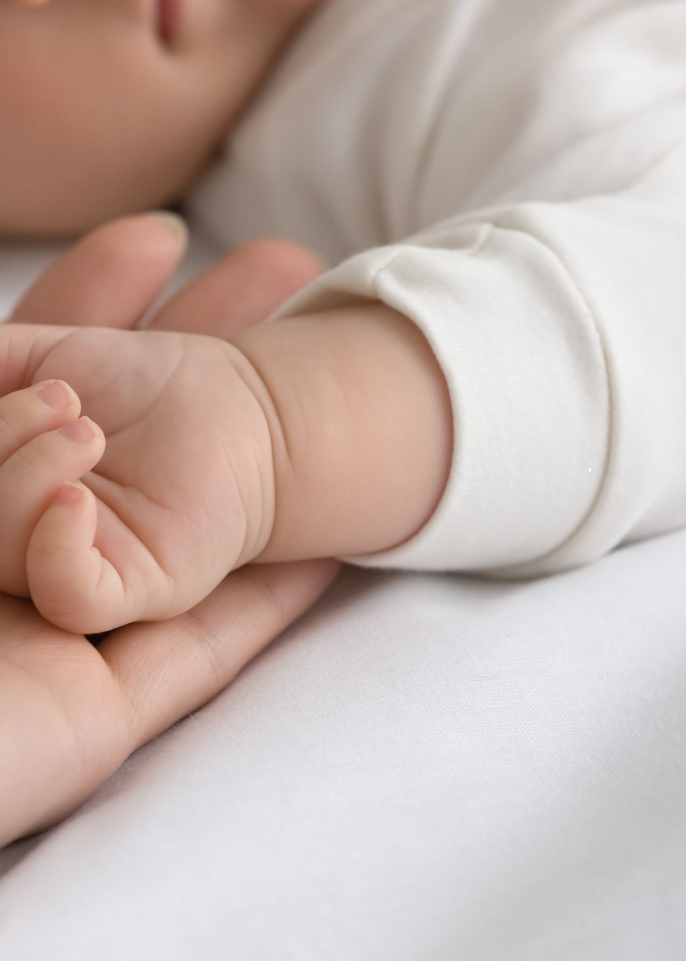Baby asleep close up on hand